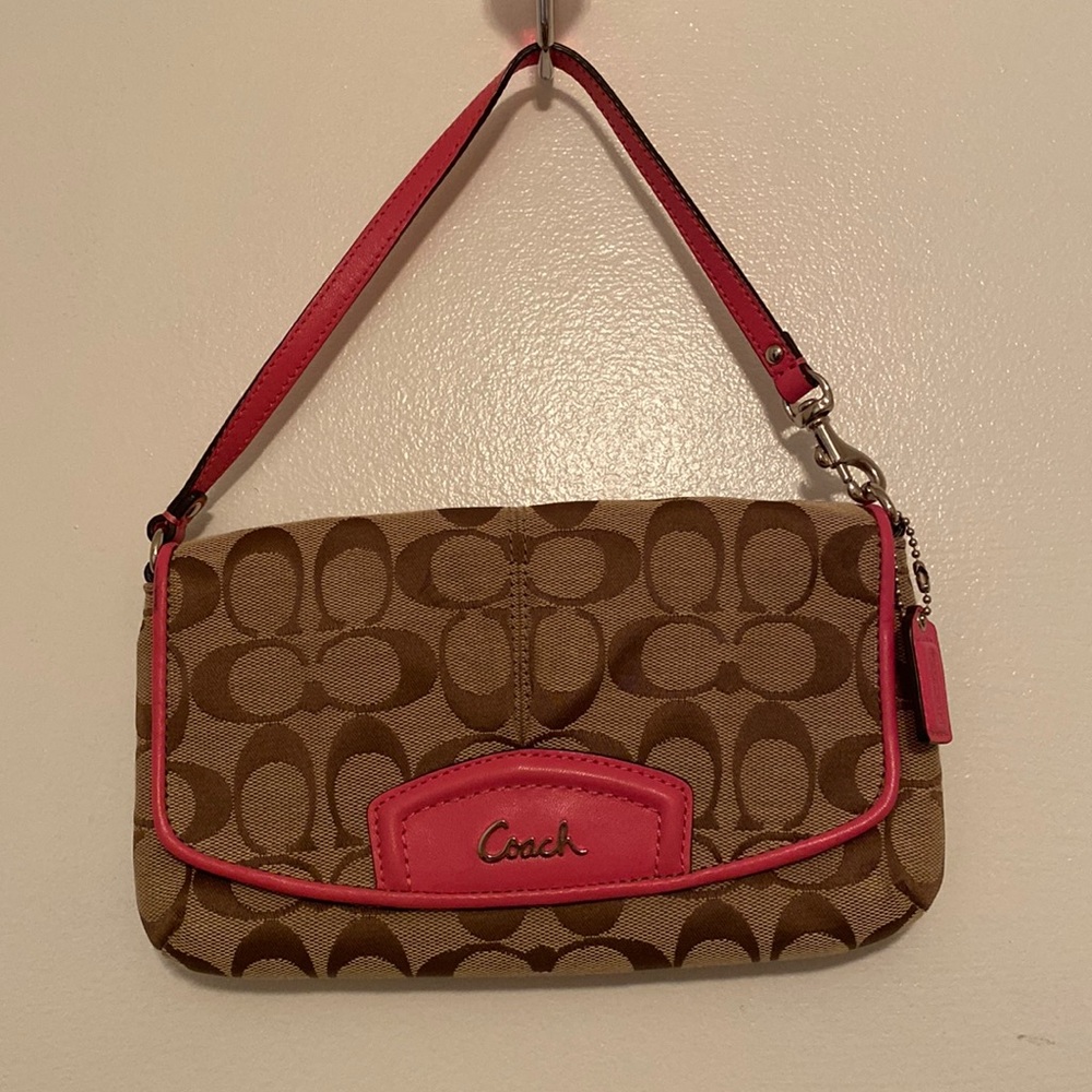 Coach wristlet with adjustable strap.